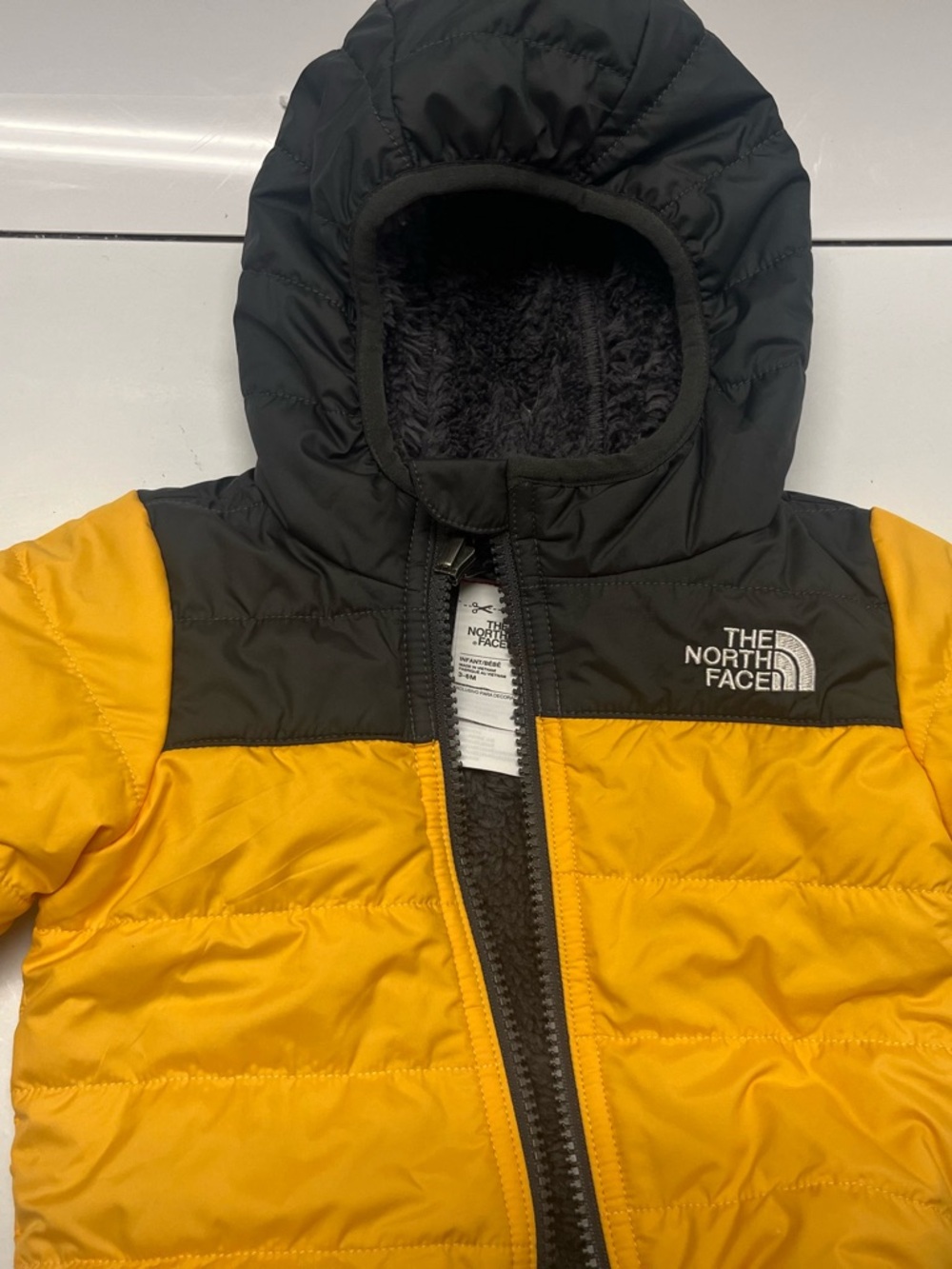 The North Face Yellow and Black Quilted Hooded Jacket